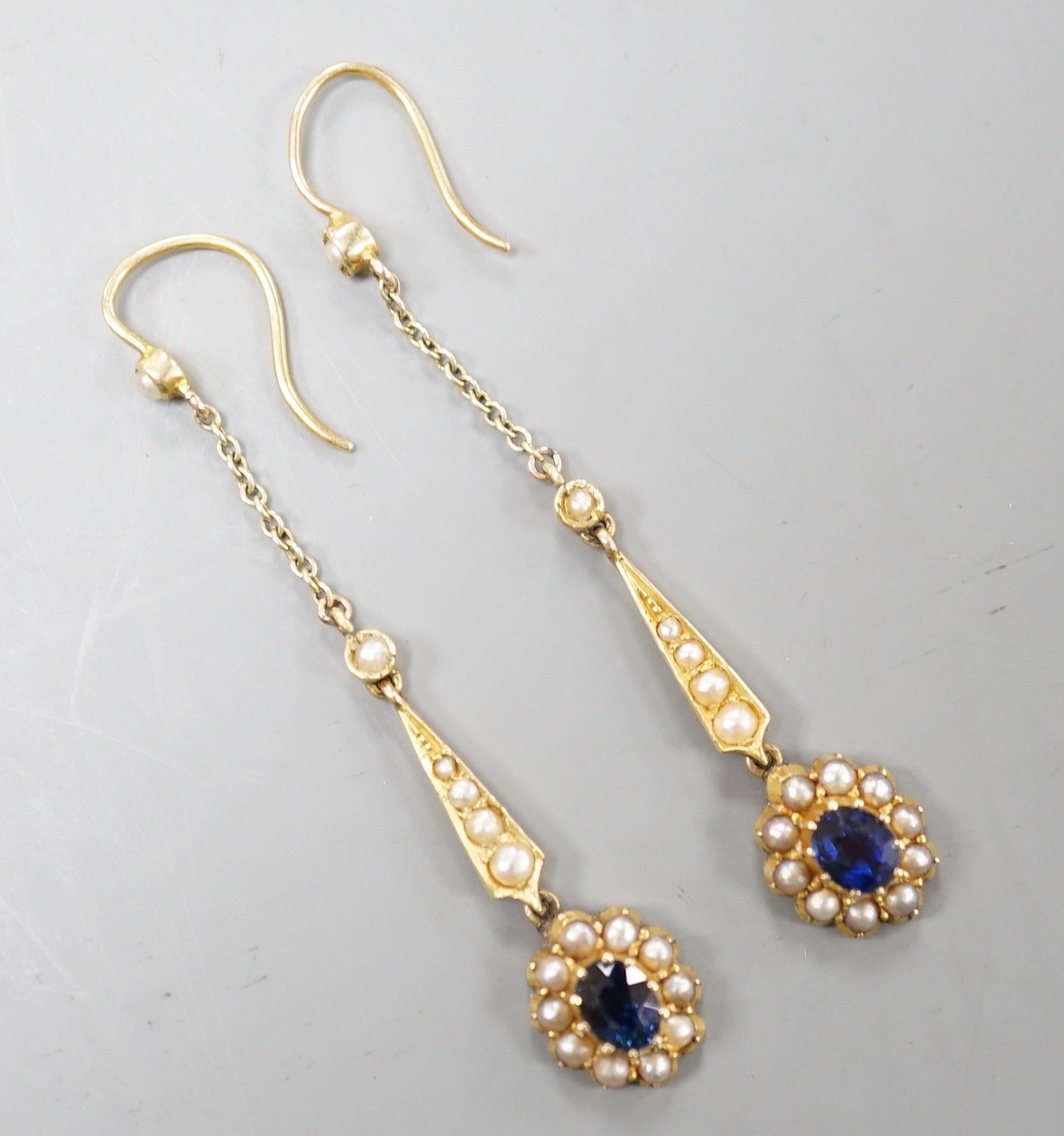 A pair of yellow metal, sapphire and seed pearl set drop earrings. 41mm, gross weight 3.4 grams.